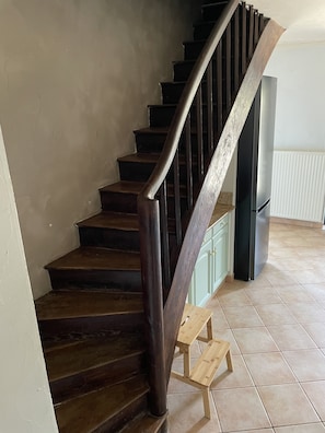 The staircase from the ground floor (living area) to the upper floor (sleeping).