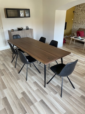 The dining table, with seating for 6. The living room is in the background.