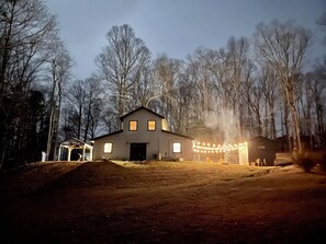 Backyard view of the house. Ample yard with firepit for bonfires. 