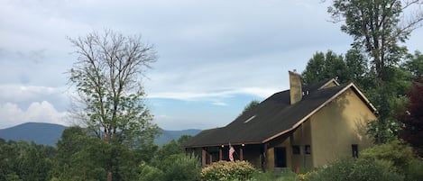 House is nestled into the hill, looking out on the Blue Ridge Mountains