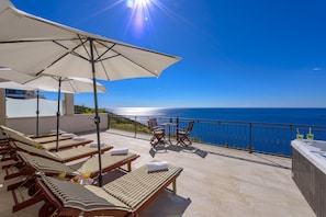 shared terrace with sun-beds, sun-umbrellas, jacuzzi and an outdoor shower