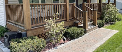 Large relaxing front porch with swing, bistro set up, love seat and chairs 