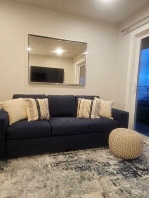 Complete remodel with beautiful blue couch that makes out into a bed.
