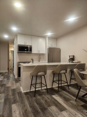 Look at this bright newly remolded kitchen!!!  Stainless steel appliances.