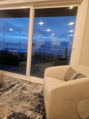 Great night view of the beach while sitting in this large comfortable chair.