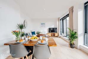 Expansive living room with designated lounge, kitchen and dining areas