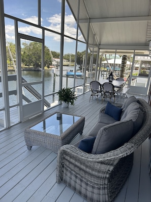 Unwind on the large screened in back porch which sits right over the water