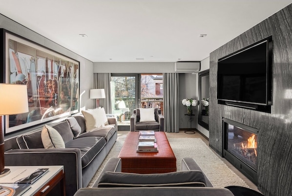 Living Room, with gas fireplace, smart TV, Printer, and balcony