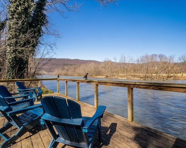 Relax by the river with serene views, perfect for fishing or unwinding on the dock. Enjoy the peaceful atmosphere and stunning waterfront scenery.