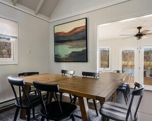 Two dining tables provides seating for 12, offering beautiful backyard views and abundant natural light.