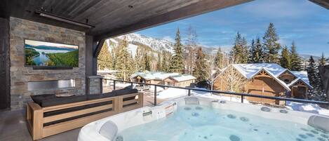 Relax and take in the mountain views from the private hot tub with heated patio, fireplace and television.