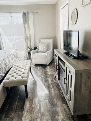 Master Bedroom with rocking recliner and electric fireplace 