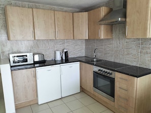 Modern fully fitted kitchen with coffee machine