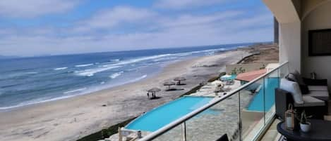 View from patio of the pools, hottubs, beach, and ocean.