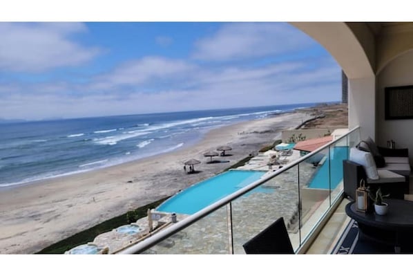 View from patio of the pools, hottubs, beach, and ocean.