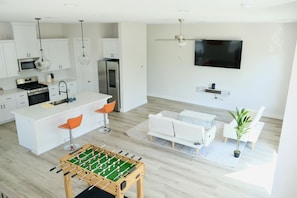 View of the living room featuring a Samsung smart fridge and smart TV