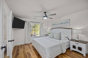 Master bedroom with King size bed, 55" tv, and blackout curtains.