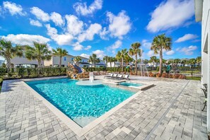 The tranquil sounds of the cascading water create a calming atmosphere for poolside relaxation.