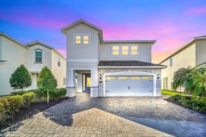 A beautifully landscaped front yard with elegant pavers and modern curb appeal welcomes you home.