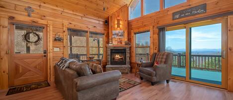 Great room/living room of this cabin with views and a cozy feel