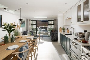 Open-plan kitchen/living/dining room opens up to rear courtyard