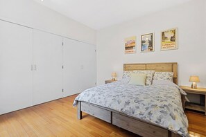 Rest easy in the primary bedroom offering a queen-size bed and built-in wardrobes.