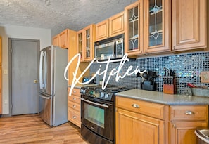 Whip up delicious meals in this modern kitchen, complete with sleek stainless steel appliances and plenty of counter space for all your culinary creations.