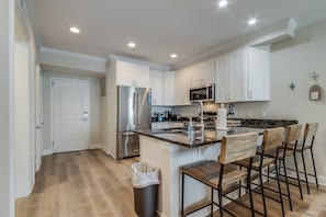 Gourmet kitchen with granite counter top and counter that seats four.