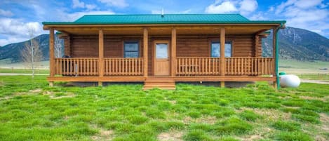 The back covered porch offers a BBQ for easy cooking at the cabin.