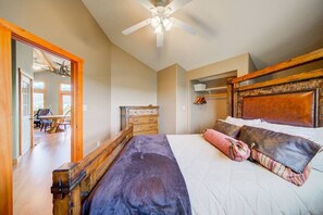 The main bedroom offers a full size bed, closet and bench.