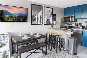 Welcome to Mountain Lodge 154! Gather around the cozy table for four and swap stories of your mountain adventures with your group.