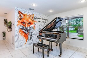 Artistic ambiance awaits with a grand piano for guests in our music and art area
