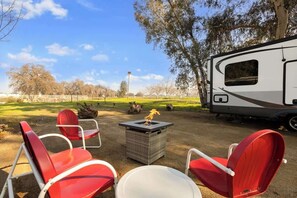 Enjoy sitting by the propane fire pit while you enjoy the outside.