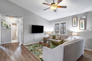 Spacious & stylish! Two comfy couches, a ceiling fan, and tons of natural light make this the perfect place to unwind. Flows seamlessly into the dining area and king bedroom.