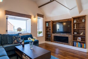 The living room with a media wall at Exmoor Barn, Somerset