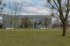 A view of a nearby park with open green space and trees, perfect for a stroll.
