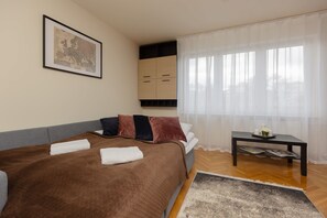 A corner of the room with a bed, combining comfort and functionality in the living space.
