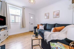 The modern living room benefits from a large corner sofa which can be converted into a double sofa bed, a 40-inch SMART TV with Netflix and plenty of space to sit down and relax.