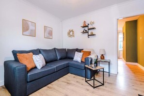 The modern living room benefits from a large corner sofa which can be converted into a double sofa bed, a 40-inch SMART TV with Netflix and plenty of space to sit down and relax.