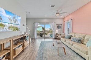 Open, airy and inviting living room with smart TV and pull out couch