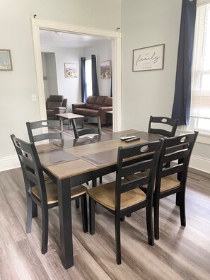 The dining room offers a spacious and inviting setting, perfect for enjoying meals with family and friends around a beautiful table, creating a warm and welcoming atmosphere.
