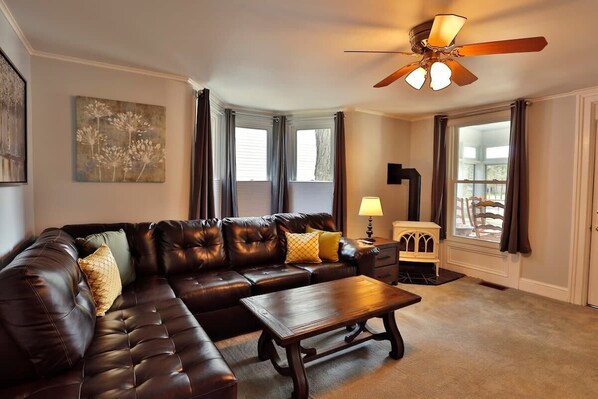 Relax in this cozy living room with comfortable couches, a flat-screen TV, and a coffee table. Enjoy over 145 channels with DirecTV for endless entertainment and relaxation.