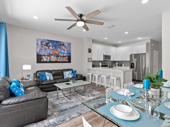 Open-concept living room flowing into fully equipped kitchen at Belle’s Villa