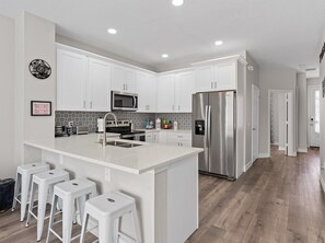 Fully equipped kitchen with large island at Belle’s Villa near Disney