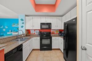 Plenty of room for the Chef of the family in this fully stocked Kitchen.