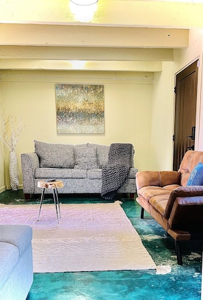 Living room w/LG 55’ TV. Full/queen sofa bed, 1 twin pull out, 1 twin Futon