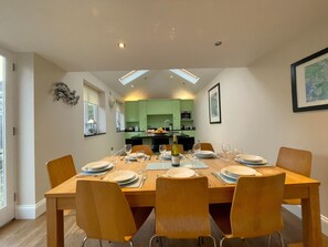 The dining table seats 8 comfortably and there is also a breakfast bar seating 3