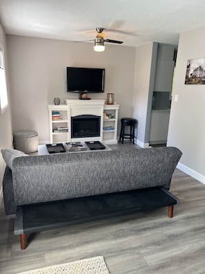 Pristine living room with Smart TV and fireplace