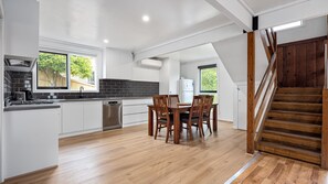 Open-concept perfection: The seamless flow between the kitchen and dining area allows for easy interaction while preparing meals and enjoying shared moments.