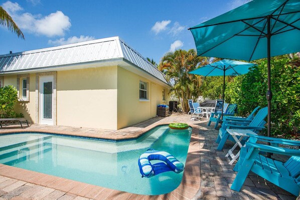 Corner shaped,  heated dipping pool, outdoor shower, table and loungers